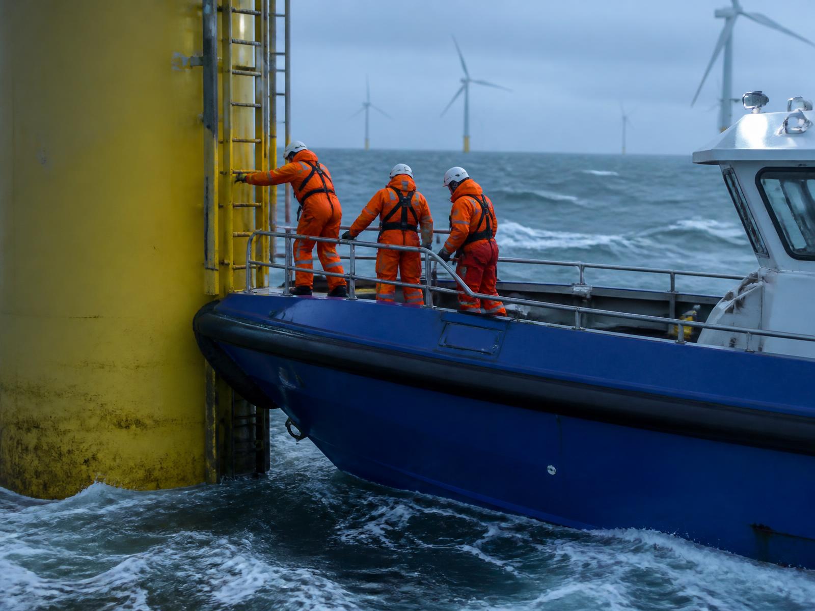 Crew transfer vessel alongside a turbine foundation